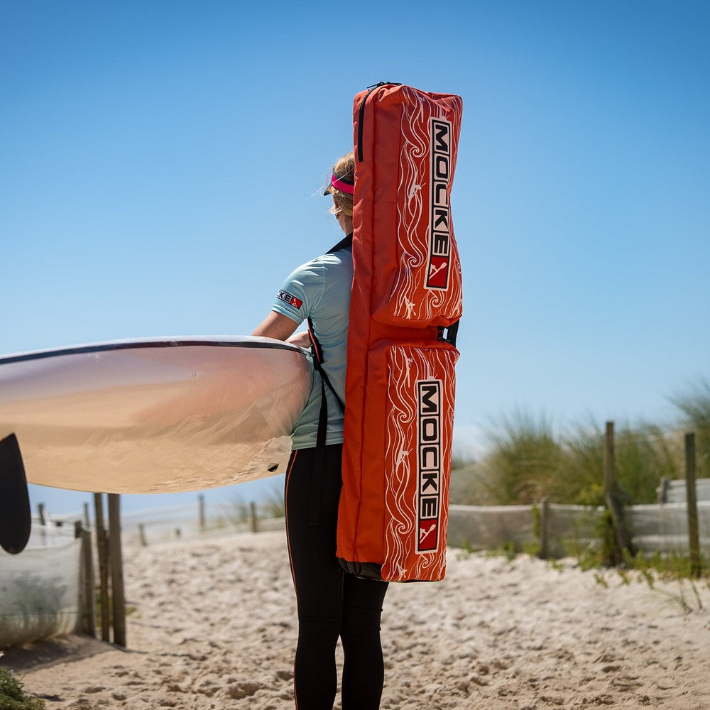 Mocke Deluxe Paddle Bag orange, lifestyle with surfski on beach